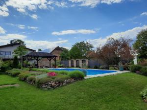 a house with a swimming pool in a yard at Ferienwohnung im Spreewald - Natur Pur in Lübben +38 photos