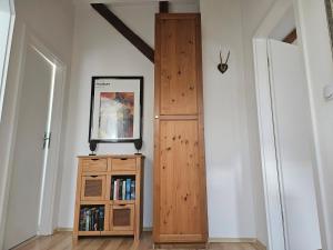 a room with a wooden door and a book shelf at Ferienwohnung Wartturmblick in Nierstein