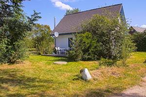 a house with a table and chairs in a yard at Ferienhaus Tüdelnest in Hessenburg