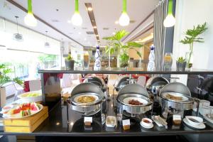 a buffet line with food in a restaurant at Alpa City Suites Hotel in Cebu City