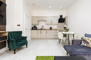 a kitchen and living room with a couch and a table at Modern City Centre Ground Floor - Apt 6 in Bradford