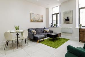 a living room with a couch and a table at Modern City Centre Ground Floor - Apt 6 in Bradford