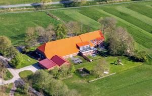 an aerial view of a large house with an orange roof at Ferienwohnung Landleben am Meer in Bensersiel