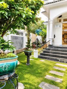 a house with a garden in front of it at Green Hillside Villa Hue in Hue