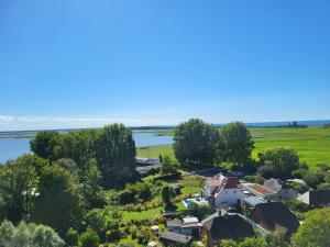 an aerial view of a small village next to a body of water at An der Schmiedestraße Strandläufer in Wustrow