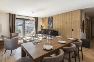 a dining room and living room with a table and chairs at Alpine Blanc - Neuf, calme & Wellness in Saint-Gervais-les-Bains