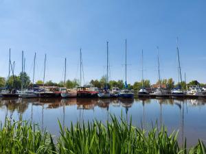 a group of boats docked in a harbor at Ferienwohnung am Kirchplatz 25561 in Weener