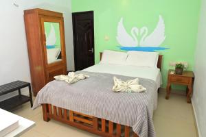 a bedroom with a bed with bows on it at Kannur Beach view Homestay in Kannur