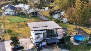 an aerial view of a house with a swimming pool at Baan Suan Papa Resort Wangmuang in Ban Nong Lom (1)