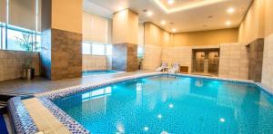 a large swimming pool in a hotel room at 1 Bedroom Apartment at Centaurus Mall in Islamabad
