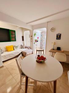 a living room with a bowl of fruit on a table at Ático Sol Vecindario in Vecindario