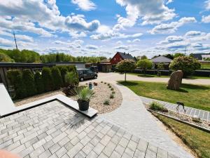 a garden with a patio and a driveway at Ferienhaus "Laila" ID 16019-2 in Möllenhagen