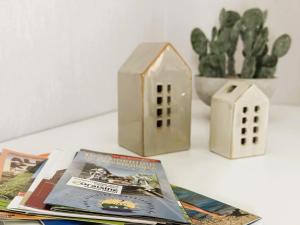 a table topped with a house and a magazine at Ferienhaus "Laila" ID 16019-2 in Möllenhagen +9 photos