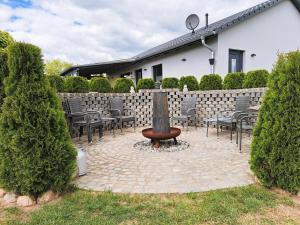 a courtyard with chairs and a fountain in front of a building at Ferienhaus "Laila" ID 16019-2 in Möllenhagen