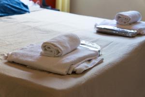 two towels sitting on top of a bed at VMHostel in Montecatini Terme