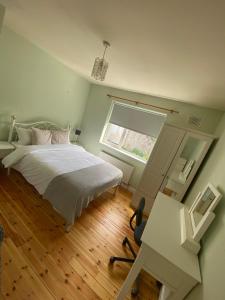 a bedroom with a bed and a desk and a window at Claddagh in Galway