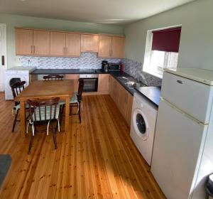 a kitchen with a wooden table and a wooden floor at Claddagh in Galway