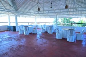 a group of tables and chairs in a pavilion at Kannur Beach view Homestay in Kannur