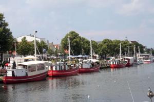 a group of boats docked in a harbor at Warnemünde Fischer`s Hus 10139 in Rostock