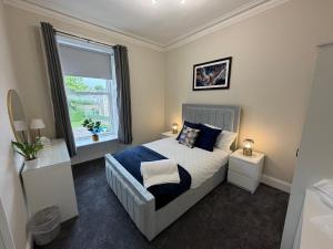 a bedroom with a bed and a large window at Prime Dundee West End 3BR Apartment, Stunning River Views, Sleeps 6 in Dundee