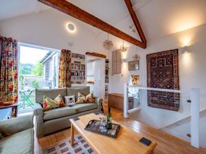 a living room with a couch and a table at Stylish Reverse-Level Retreat for couples in Totnes
