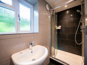 a bathroom with a sink and a shower at Stylish Reverse-Level Retreat for couples in Totnes +30 photos