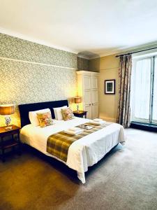 a bedroom with a large bed and a large window at George Hotel & Granary in Frome