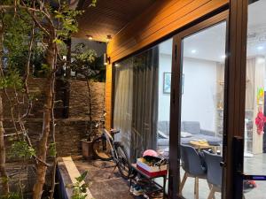 a house with a bike parked in front of a window at Đông Hương Home in Cat Ba