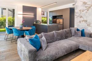 a living room with a large couch and a table at Mirabello Private Pool Apartment in Bardolino