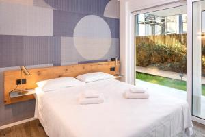 a bedroom with a bed with two white pillows on it at Mirabello Private Pool Apartment in Bardolino +42 photos