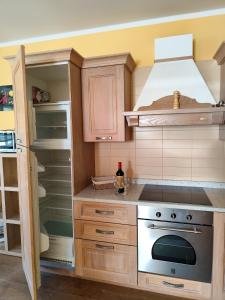 a kitchen with a stove and a refrigerator at Appartements Bel Monte - Kärnten Card im Sommer inklusive in Bad Kleinkirchheim