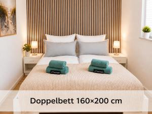 a bedroom with a bed with two pillows on it at Schwedenglück - Wald-Auszeit für 2 in Dahlen