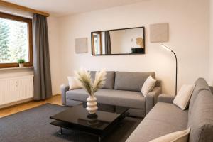 a living room with a couch and a table at Appartement zur Gemütlichkeit - Ski Juwel im Alpbachtal in Wörgl