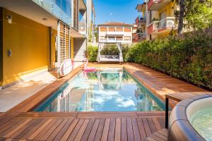 a swimming pool on a deck next to a building at Mirabello Private Pool Apartment in Bardolino