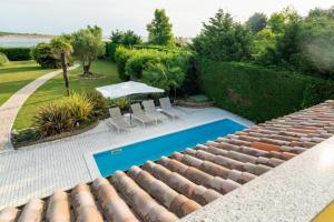 a view from the roof of a house with a swimming pool at Scirocco in Isola Albarella