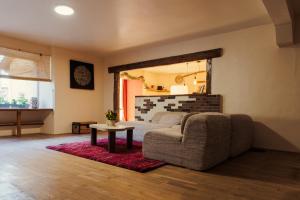 a living room with a couch and a table at Ma Bégude in Rieutord