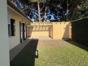 a backyard of a house with a fence at Adria in Isola Albarella