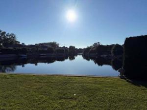 a view of a river with the sun in the sky at Adria in Isola Albarella