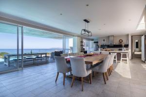 a kitchen and dining room with a table and chairs at Seascape in Plettenberg Bay