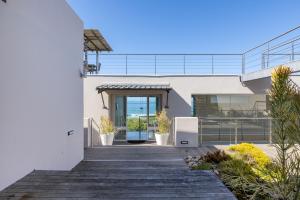 a house with a boardwalk leading to the front door at Seascape in Plettenberg Bay