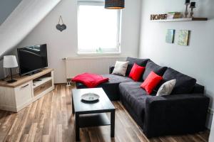 a living room with a couch and a tv at Ferienhaus Voss in Alt Zauche