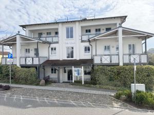 a large white building on the side of a street at Villa Linde Whg 23 mit Terrasse in Göhren