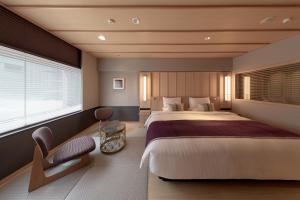 a bedroom with a large bed and a window at Kyoto Century Hotel in Kyoto