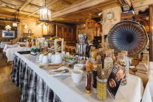 a long table in a room with many bottles at Camana Veglia in Livigno