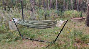 a hammock in a field with a fence at Wasserturm Spreewitz in Spreewitz