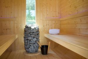 a wooden sauna with a large stack of logs at Fleesenseetreppe rechts in Göhren-Lebbin