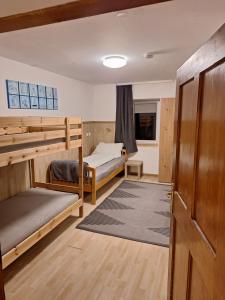 a room with two bunk beds and a hallway at Zirnberg Appartements in Flattach
