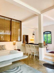 a bedroom with a bed and a desk and chairs at Baker's cottage in Kosgoda +64 photos