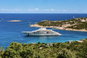 a cruise ship in the water near a small island at Big Pevero Sea View House 8 Three Bedrooms in Porto Cervo
