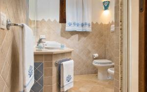 a bathroom with a toilet and a sink at Big Pevero Sea View House 8 Three Bedrooms in Porto Cervo